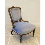 A Victorian ebonised and walnut Aesthetic movement nursing chair, in blue velour, the padded back