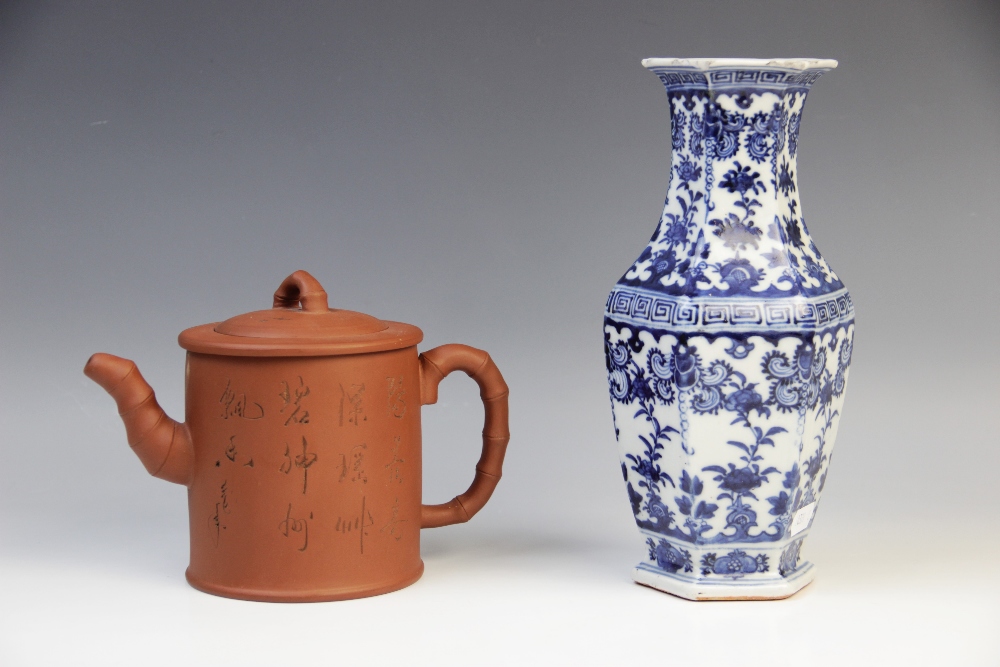 A Chinese Yixing terracotta teapot and cover, of cylinder form with stylised bamboo handle, spout