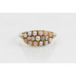 A Victorian diamond, pearl and coral ring, the navette shaped head comprising four old cut