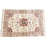 A gold ground full pile Kashmir rug, with a central floral medallion design 170cm x 120cm