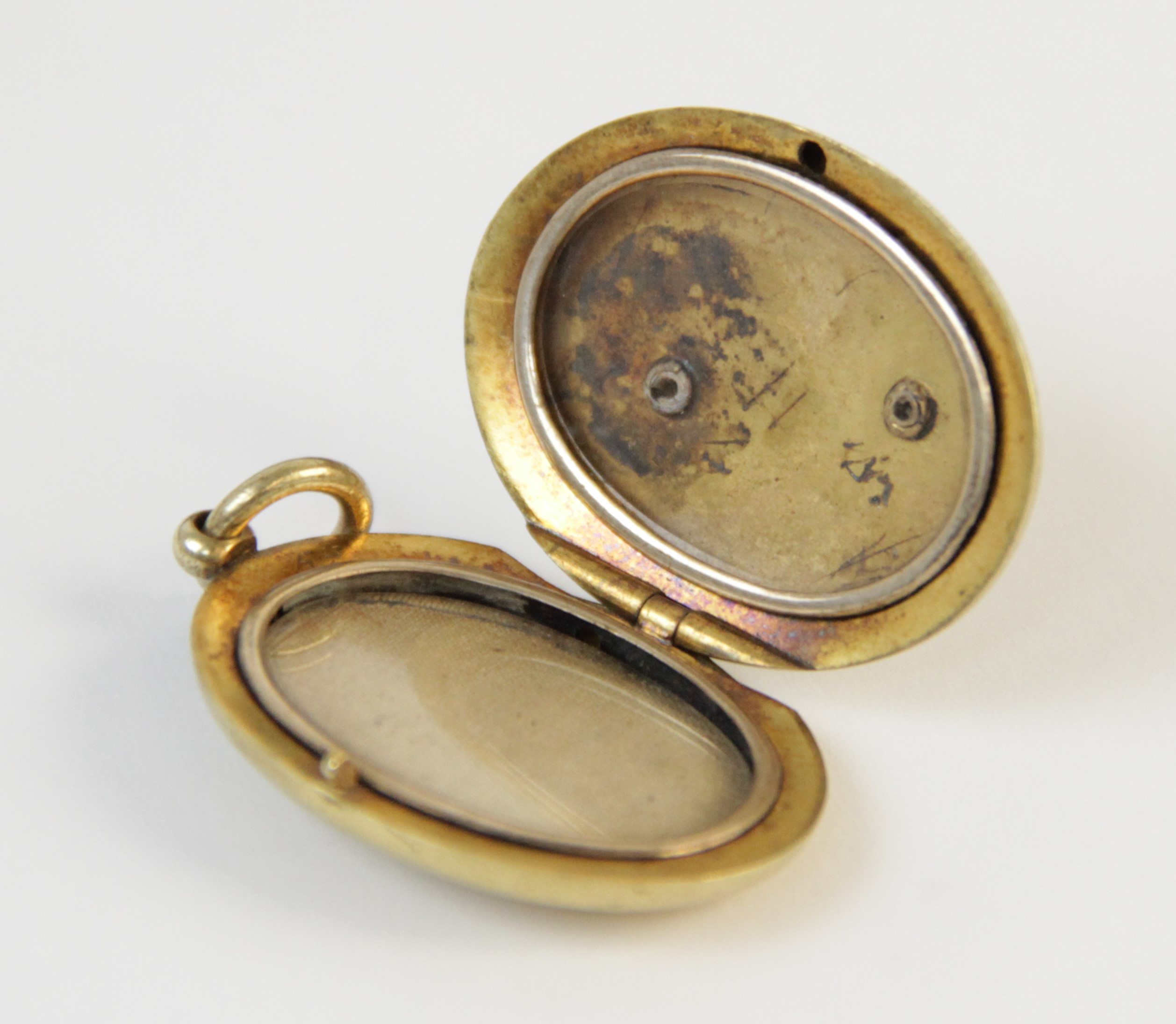 An early 20th century gold coloured enamelled locket pendant, the oval form locket with a blue - Image 6 of 8