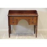 A late 19th century mahogany dressing table, the three quarter galleried top with a gadrooned