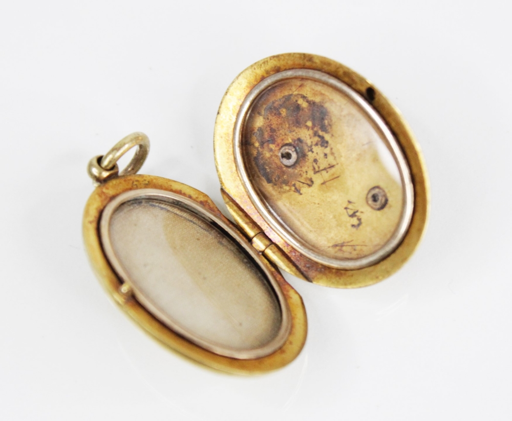 An early 20th century gold coloured enamelled locket pendant, the oval form locket with a blue - Image 3 of 8