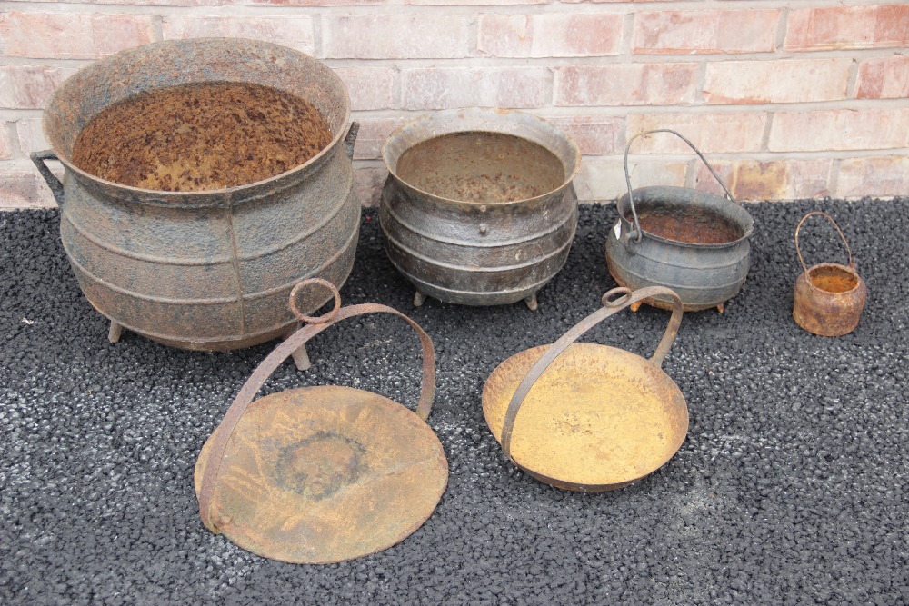 A cast iron cauldron, of typical swelling form, 35cm H x 39cm D, along with two graduated smaller