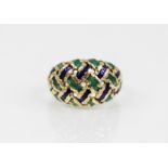 An 18ct gold enamelled ring, the pierced braided design head decorated with green and blue enamel,