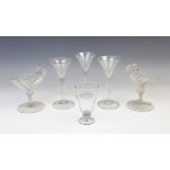 Three wine or cordial glasses, 18th century, each of conical form with folded foot and unground