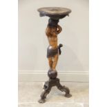 An Italian stained and carved hardwood cherub figural pedestal table, late 19th/early 20th