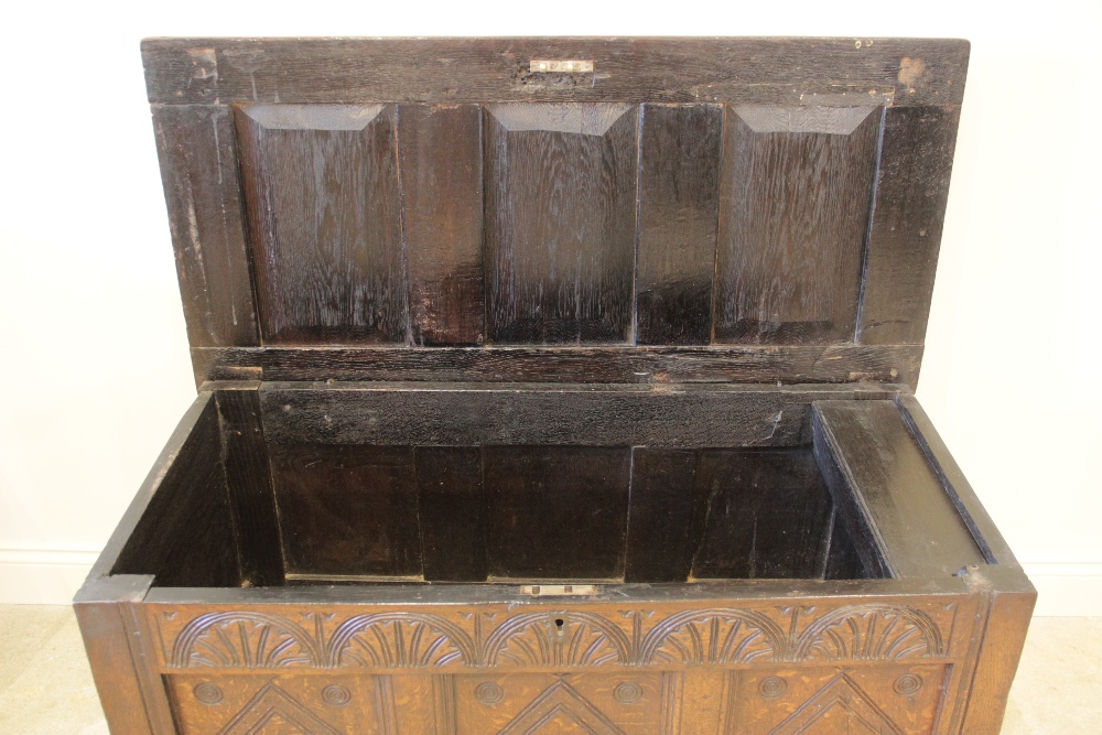 A late 17th/early 18th century oak coffer, the three panel top opening to a fitted candle box, above - Image 2 of 3