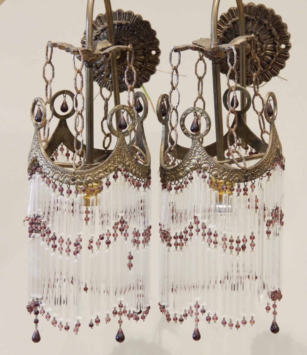 A pair of French gilt metal wall light fittings, early 20th century, each with a cast circular