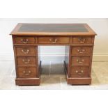 A late 19th century walnut twin pedestal desk, the rectangular moulded top with a later inset