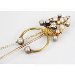 A 19th century and later diamond and pearl stick pin, the yellow metal foliate design terminal