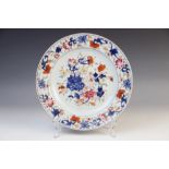 An 18th century Chinese Imari plate, the circular plate decorated with a central depiction of floral