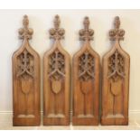 Four English Gothic revival oak pew ends, 19th century, each of ogee gothic arch form with tri-