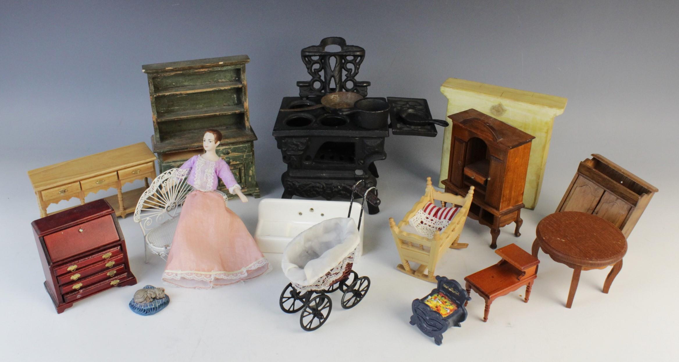 A selection of vintage dolls house furniture and accessories, to include a cast iron range cooker,