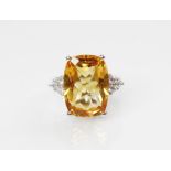 A citrine and diamond 18ct gold ring, the central rectangular mixed cut citrine (measuring 18mm L