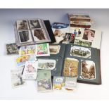 A collection of postcards to three albums and a box, early 20th century and later, to include