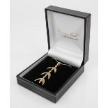 A suite of 9ct gold jewellery by Catherine Best, comprising a 9ct gold floral design pendant, 54mm