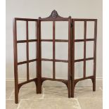 A 19th century mahogany three panel folding screen, the central panel surmounted with a carved