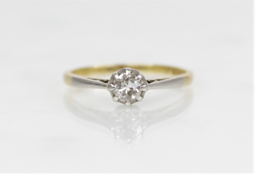 A diamond solitaire ring, the central round brilliant cut diamond (weighing approximately 0.20