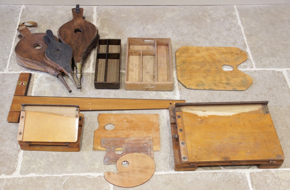 A collection of artists palettes, early 20th century, two wooden paint trays, two folding paper