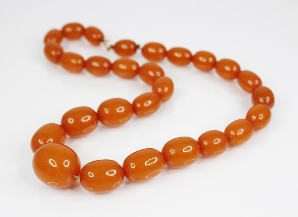 An amber-coloured bead necklace, comprising twenty-seven oval polished beads (measuring between 15mm - Image 2 of 2