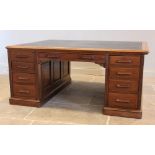 A Victorian mahogany twin pedestal partners desk, the rectangular moulded top inset with a gilt