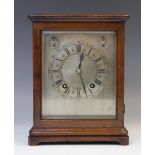 An early 20th century walnut cased Winterhalder & Hofmeier eight day mantel clock, retailed by