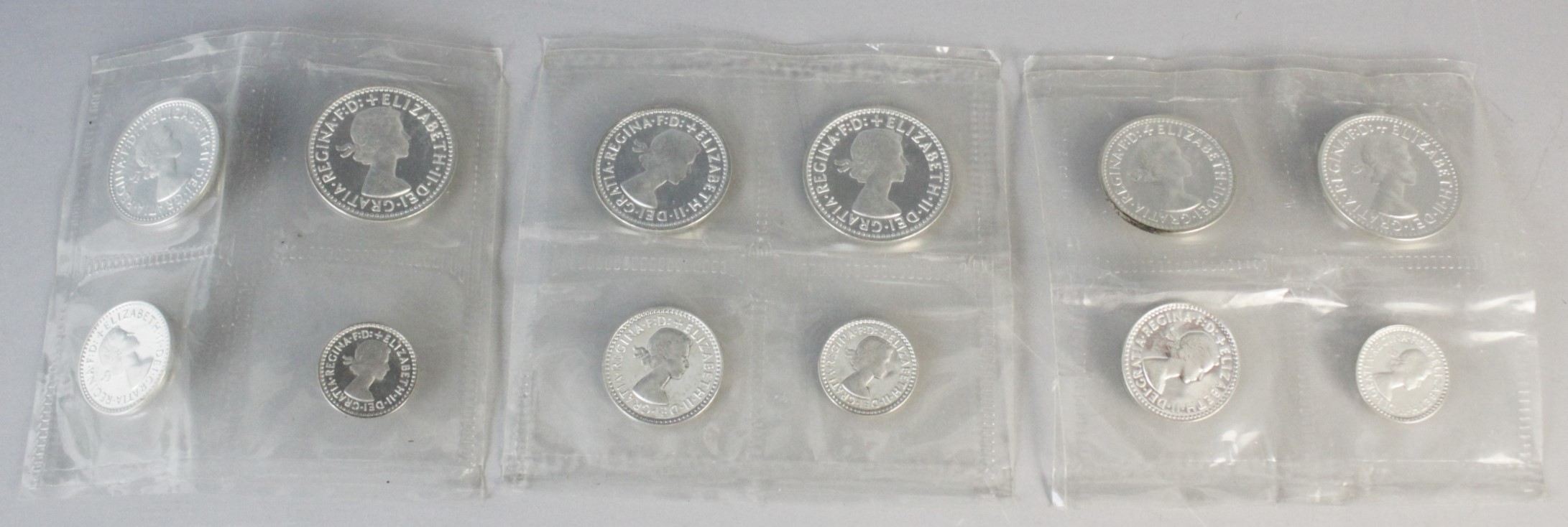 Three sealed Royal Mint sets of four Maundy money coins, each dated 1988, in a white leather