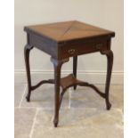 An Edwardian mahogany envelope bridge table, the square quarter folding top above a single frieze