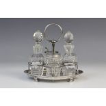 A Victorian four-piece silver and cut glass cruet set and stand by John Grinsell & Sons, London