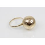 A 1960's Finnish 14ct gold dress ring, designed as a spherical bauble with textured decoration, 20mm