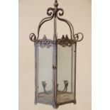 An early 20th century hexagonal wrought iron hanging candle lantern, the six rope twist supports