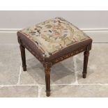 An early 20th century stained beech footstool, with tapestry upholstered square top above a carved