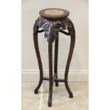 An early 20th century Chinese carved hardwood and rouge marble urn stand, the circular top with