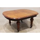 A Victorian mahogany extending dining table, the oval table top with a moulded edge above a plain