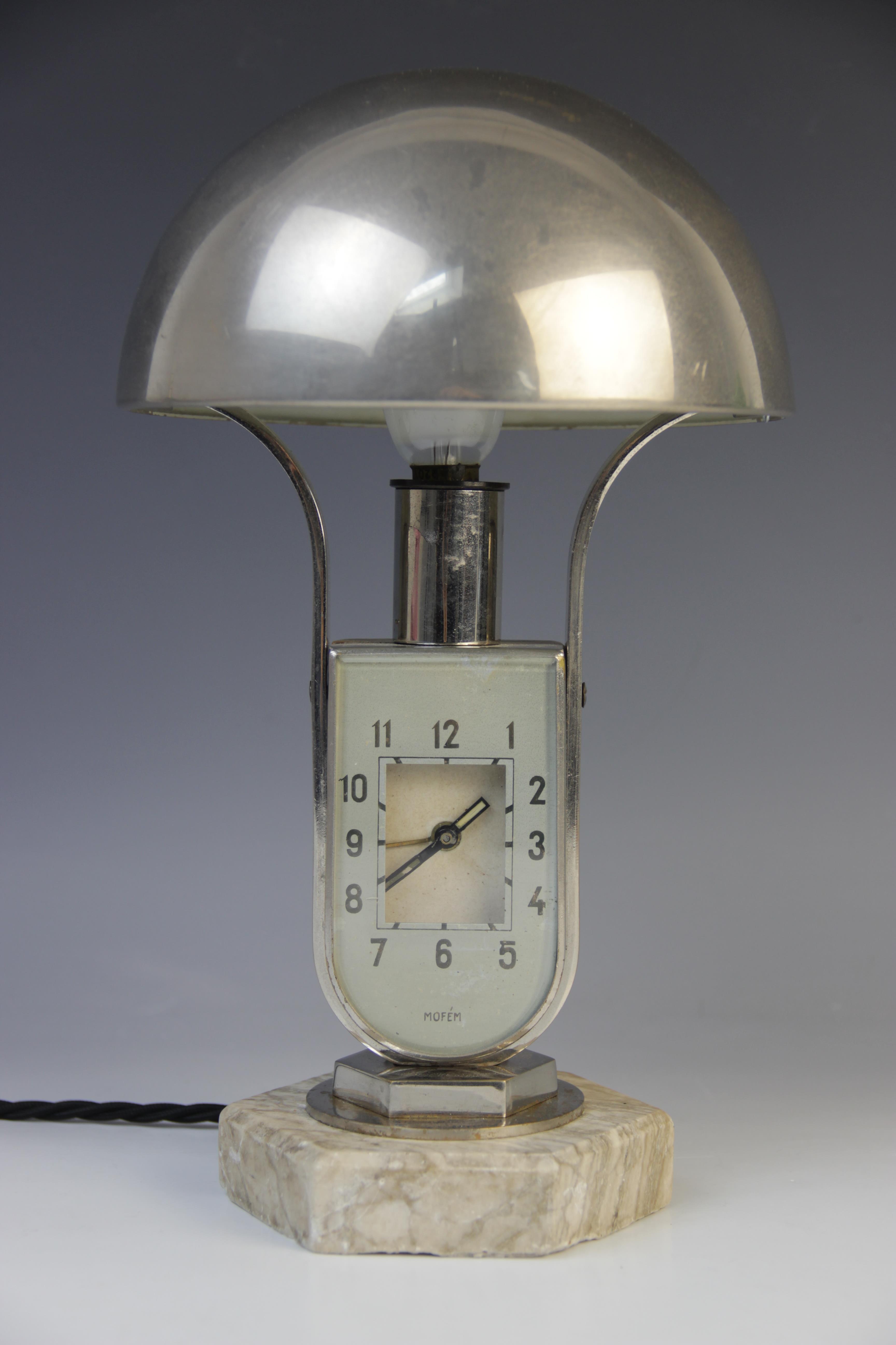 A Hungarian Art Deco clock lamp by Mofem, early 20th century, the lamp with nickel plated tilting