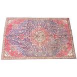 A rich blue ground Persian carpet, the central floral medallion enclosed by conforming red