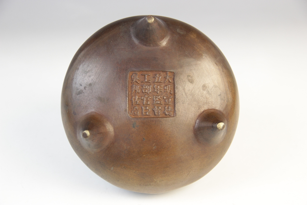 A Chinese bronze censer, Xuande mark, of compressed circular form raised on three feet, sixteen - Bild 2 aus 2