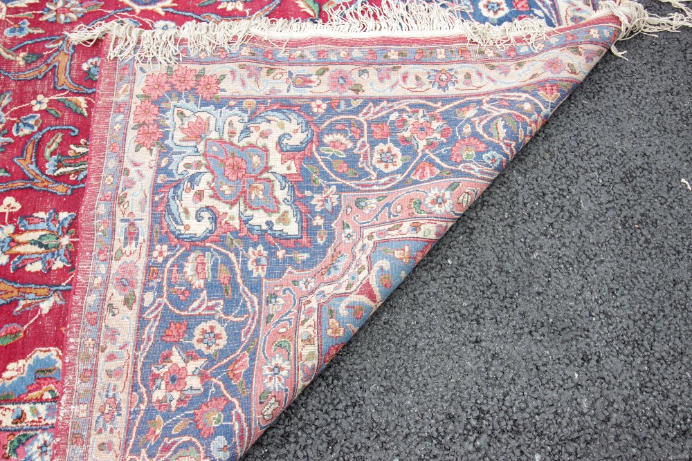 A Caucasian wool rug, the central blue lozenge shaped medallion upon a red ground with trailing - Image 2 of 2