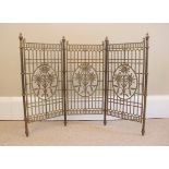 A brass floral three panel fire screen, 20th century, each panel of trellis form with central cast