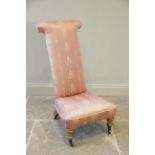 A Victorian prie dieu chair, of typical high back form, covered in satin fabric and raised upon gilt