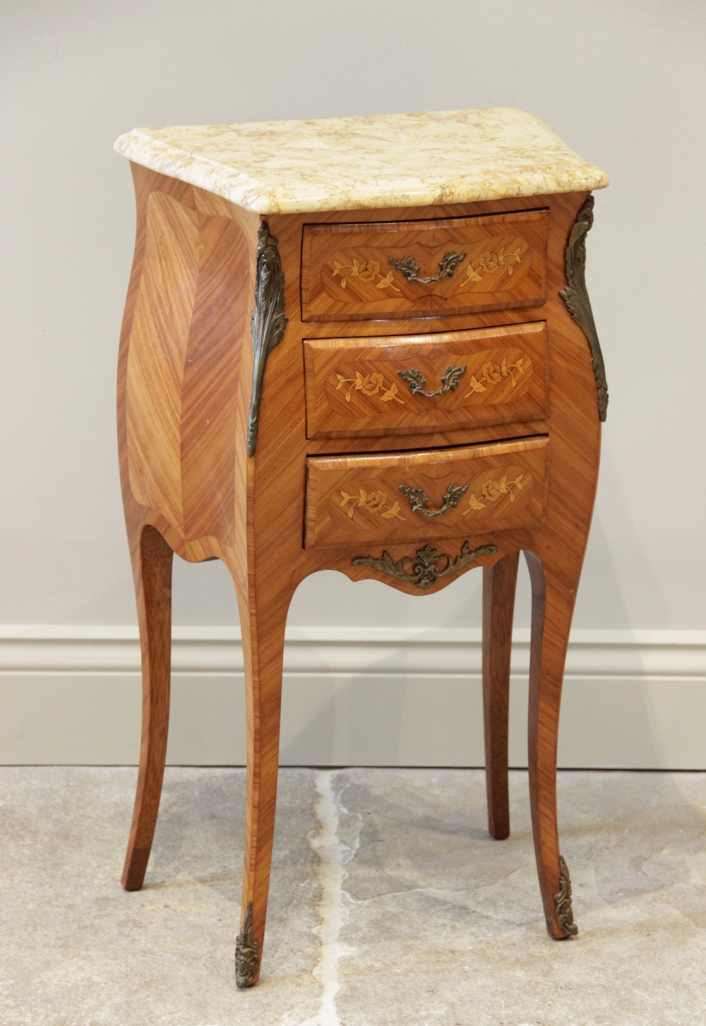 A Louis XV style kingwood marble top bombe bedside chest, mid 20th century, the shaped marble top