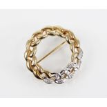 A 9ct gold diamond set wreath brooch, the circular curb-link wreath in yellow and white gold set