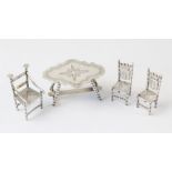 A selection of miniature continental silver coloured doll's house furniture, to include; a bobbin-