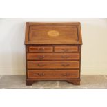 An Edwardian Sheraton revival mahogany and satinwood crossbanded bureau, the fall front centred with