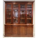 A mid 19th century mahogany library bookcase, the moulded cornice above a plain frieze and two pairs