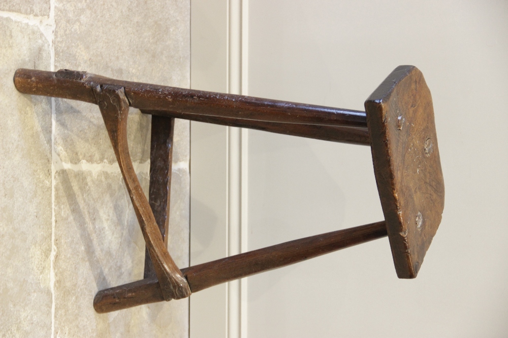 An early 19th century ash and elm primitive cutlers stool, the rough cut slab top raised upon - Image 2 of 5