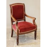 A Victorian mahogany open library armchair, the padded back extending to down swept arms and