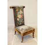 A Victorian walnut and upholstered prie dieu chair, the foliate tapestry high back flanked by barley