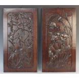 A pair of Chinese hardwood panels, 20th century, each of rectangular form with relief carving